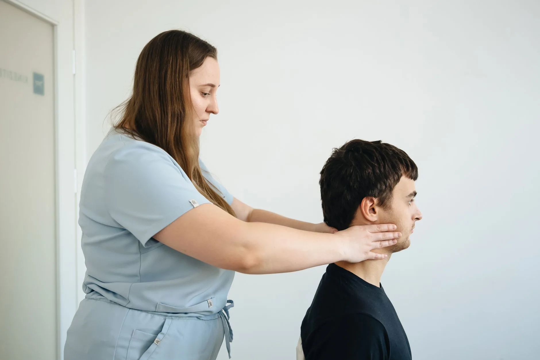 Chiropractor performing a precise neck adjustment on a patient