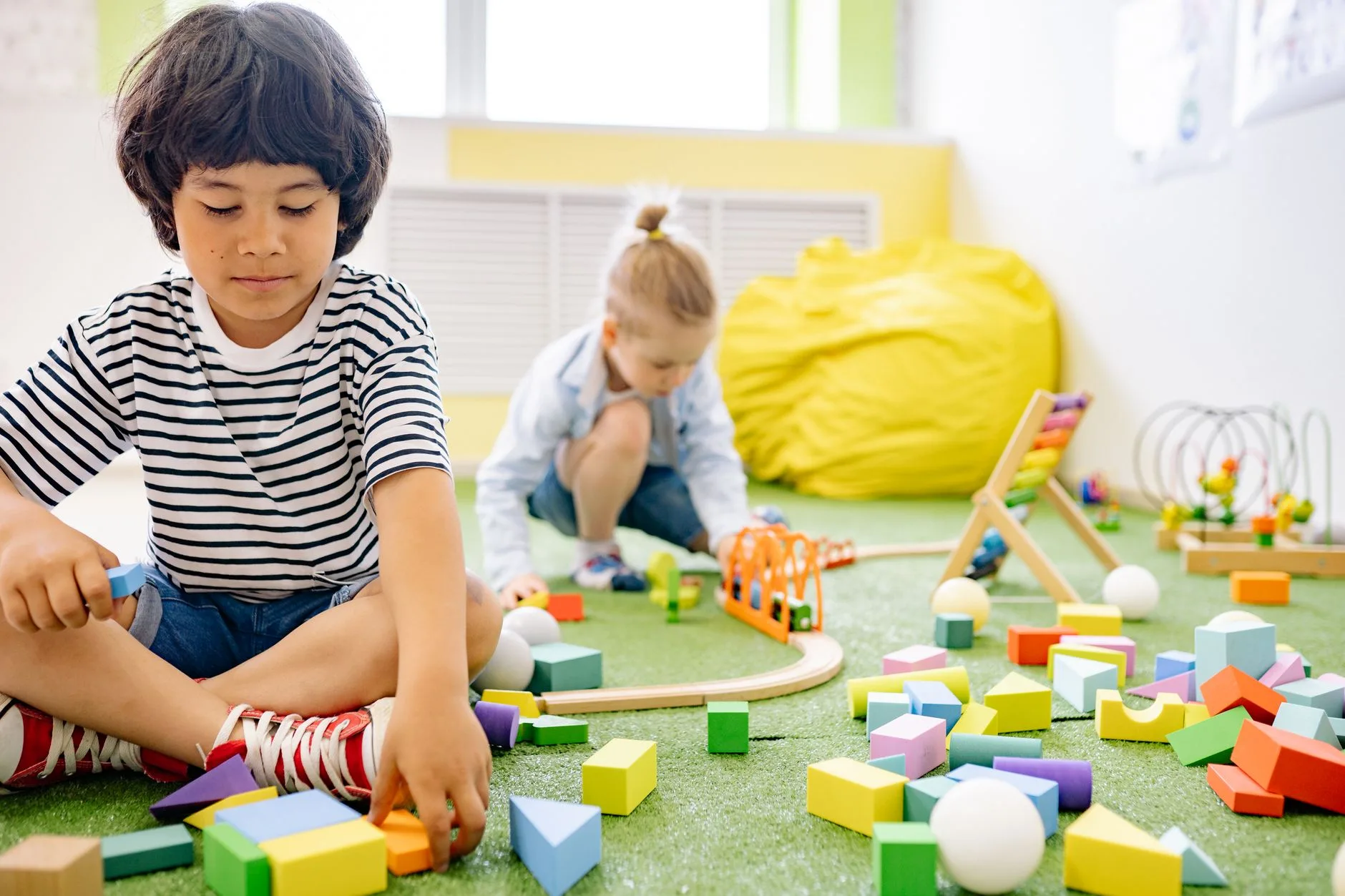 Children learning and playing together in a bright daycare classroom