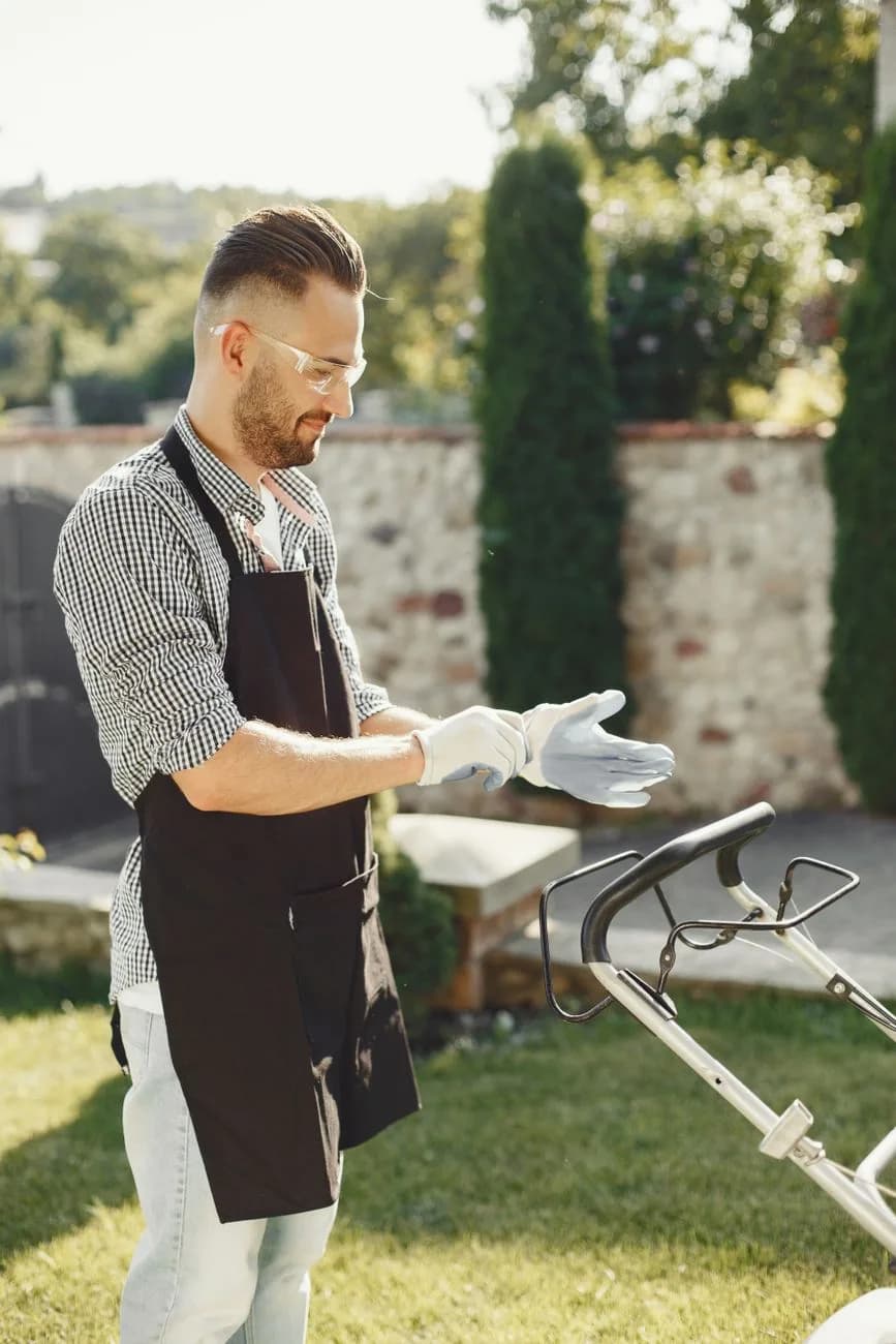 Landscaper preparing to mow a lawn on a sunny day