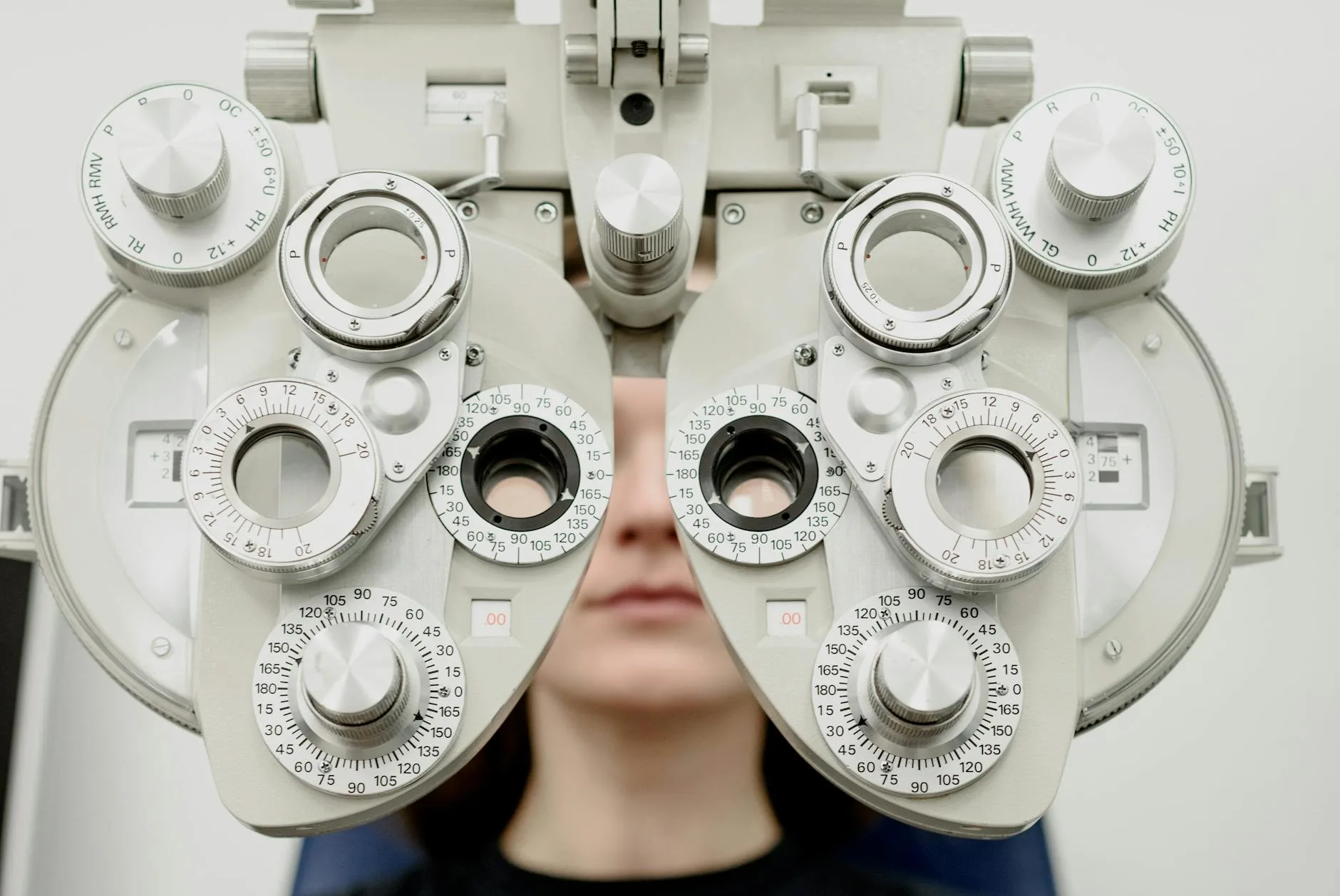 Patient receiving an eye exam with an optical testing device